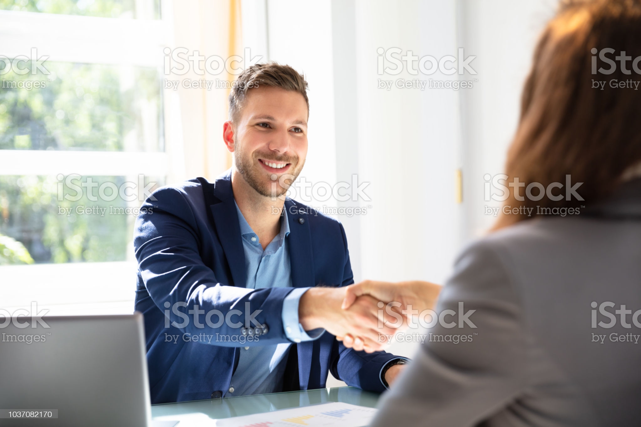 Smiling Young Businessman Shaking Hands With His Partner